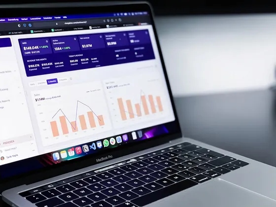 Laptop displaying a marketing dashboard with bar and line charts