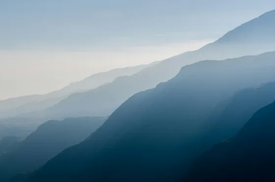 Misty mountain ridges fading into the distance